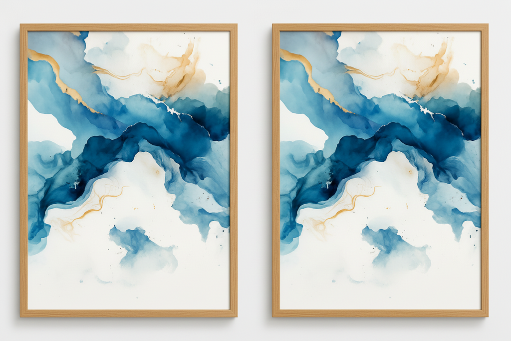 Two abstract art prints with blue and white colors and gold accents in wooden frames on a white wall.